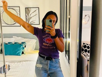 Lola Simone Rock is wearing a purple tee and a Demin jeans in the picture.